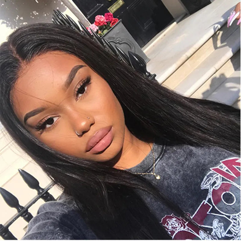 Long straight black synthetic wig with centre parting and fringe on a mannequin head.