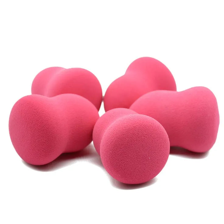 Pink teardrop-shaped makeup blending sponge on a flat surface
