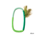 Green circular cotton rope cat toy with feather attachments for chewing and interactive play