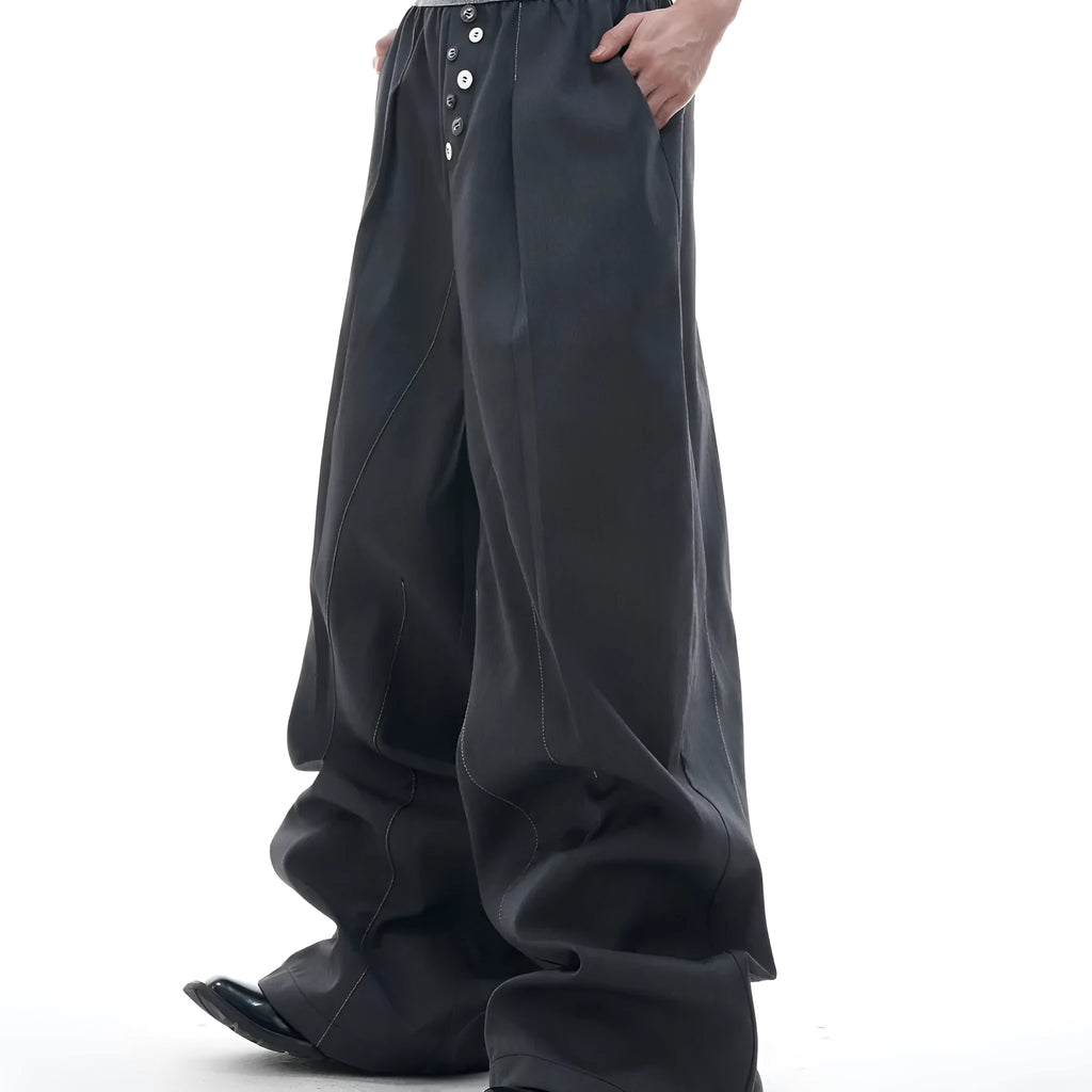 High-waisted drooping straight-leg trousers in black with button open line design detail.