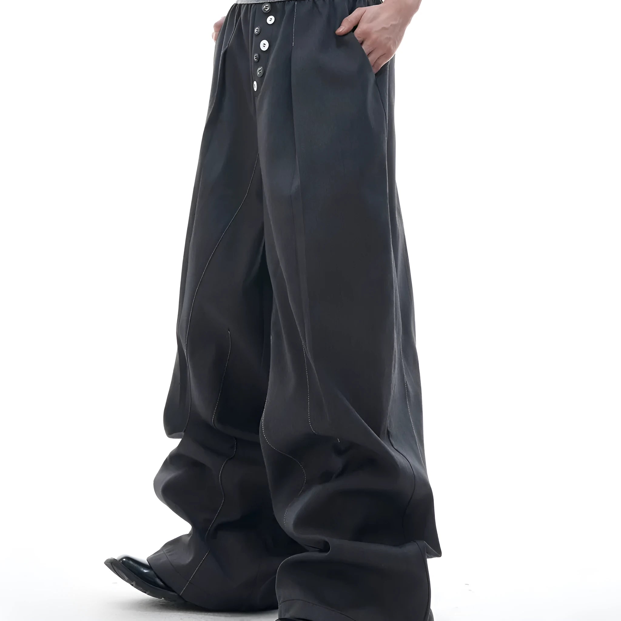 High-waisted drooping straight-leg trousers in black with button open line design detail.