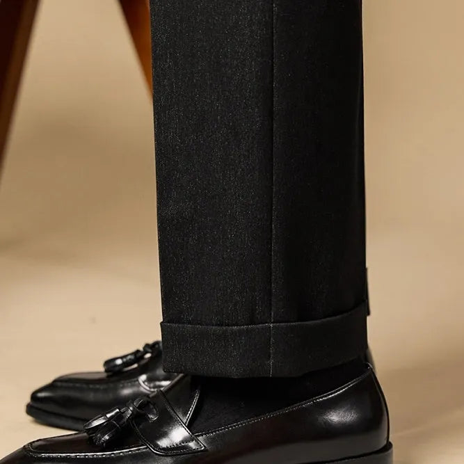 Men's black polished leather tassel loafers with a pigskin lining and rubber sole