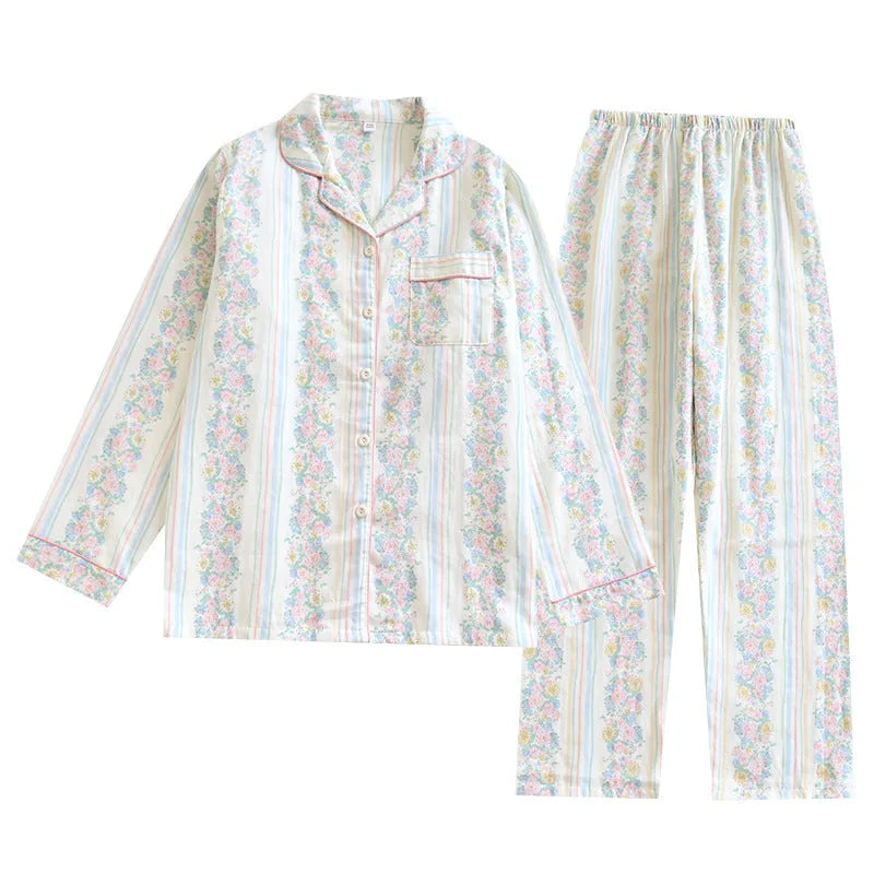 Woman wearing a red fruit print cotton gauze long-sleeved pyjama top and matching trousers.