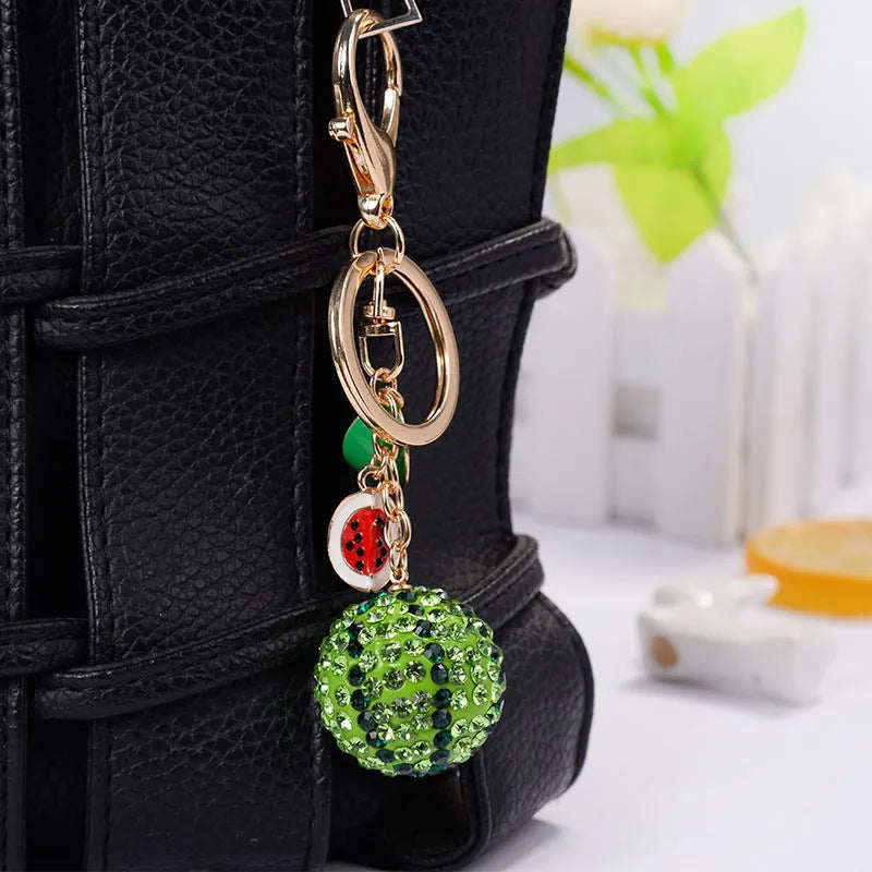 Green zinc alloy watermelon keychain shown at 12cm length.