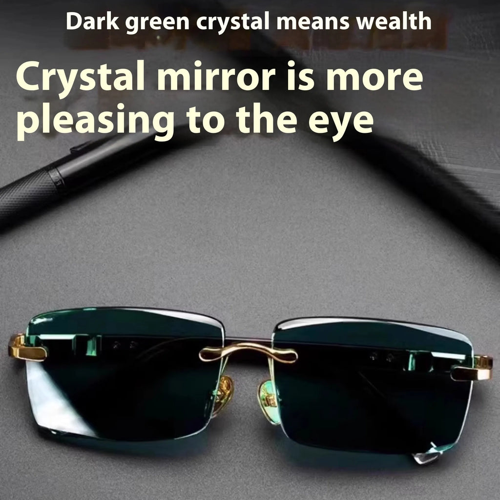 A pair of frameless sunglasses with dark green crystal lenses, shown with a glasses case and cleaning cloth.
