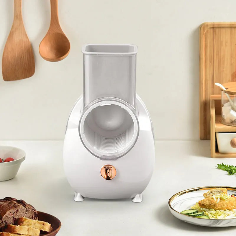 White electric vegetable slicer with rotary grater and suction base on kitchen counter
