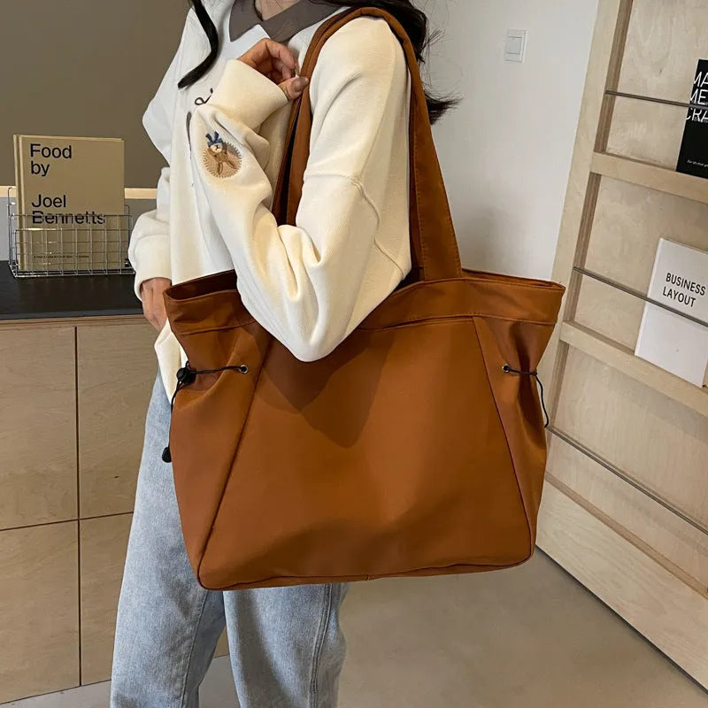 Oxford cloth shoulder tote bag in folding design showing soft construction and shoulder strap