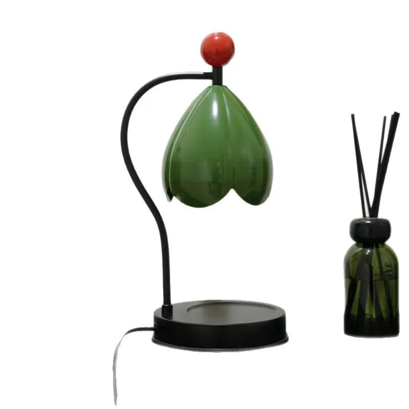 Linglan ancient style cream white melting wax lamp with metal holder on a desk.