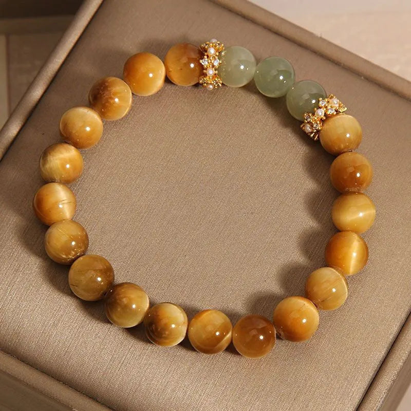 Natural yellow tiger's eye and Hetian jade bead bracelet in a U-shape, showing golden gourd design.