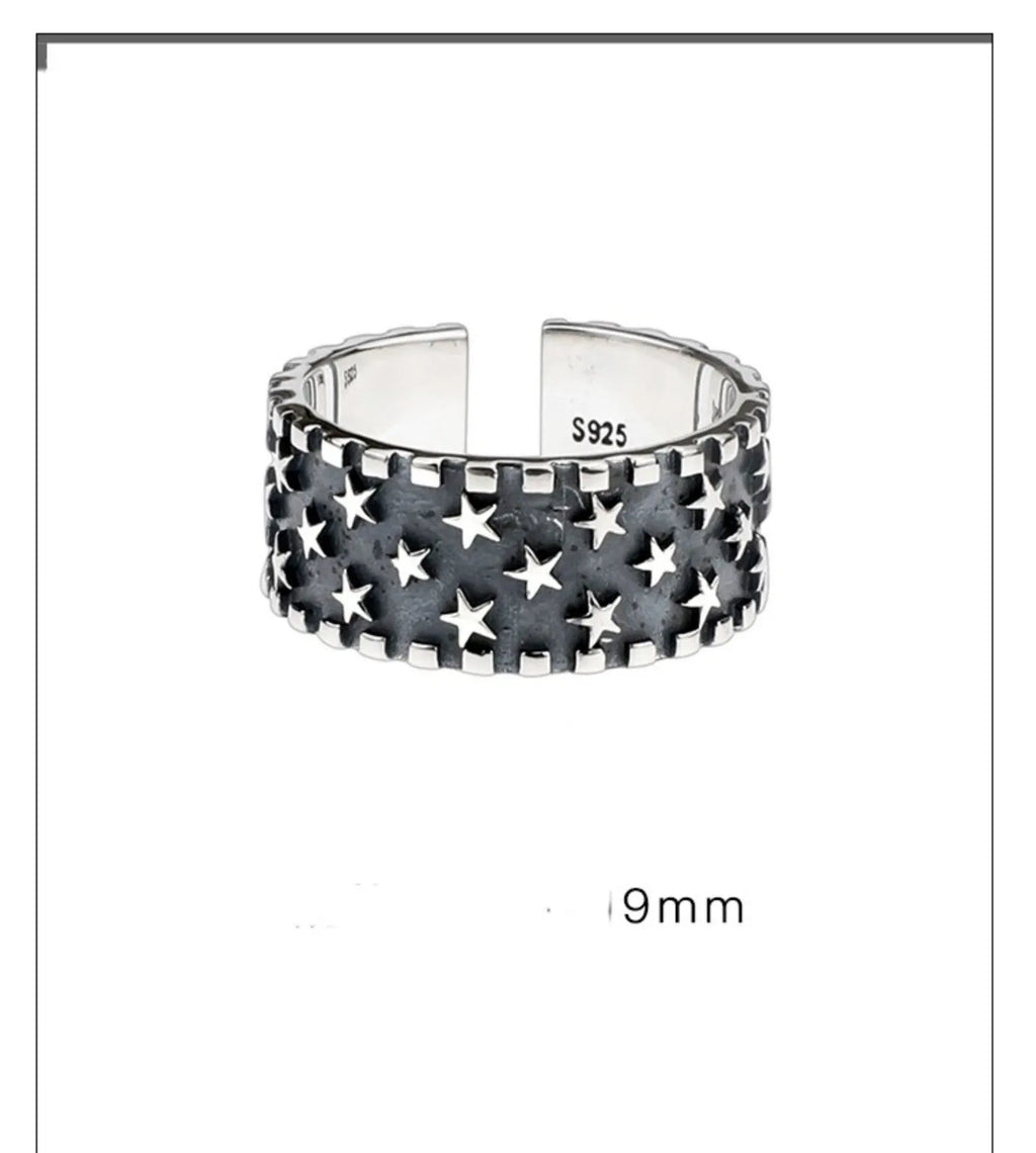 Adjustable silver ring with a geometric pattern of multiple five-pointed stars on a white background.
