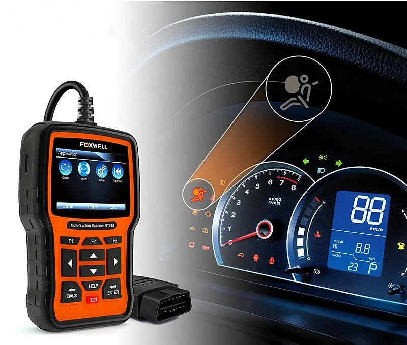 Foxwell NT510 orange and black automotive diagnostic scanner with data cable on workbench
