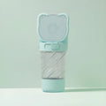 Green 3-in-1 portable pet water bottle with water dispenser, food container, and garbage bag compartment