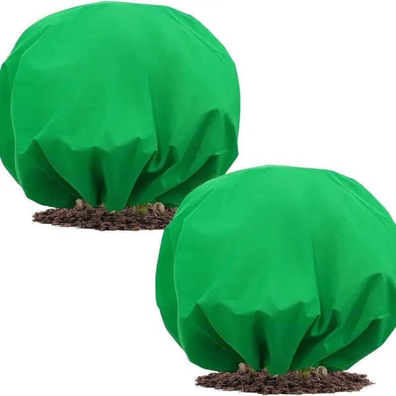 Round green non-woven plant frost cover with drawstring resting on grass, showing 1.9m diameter size