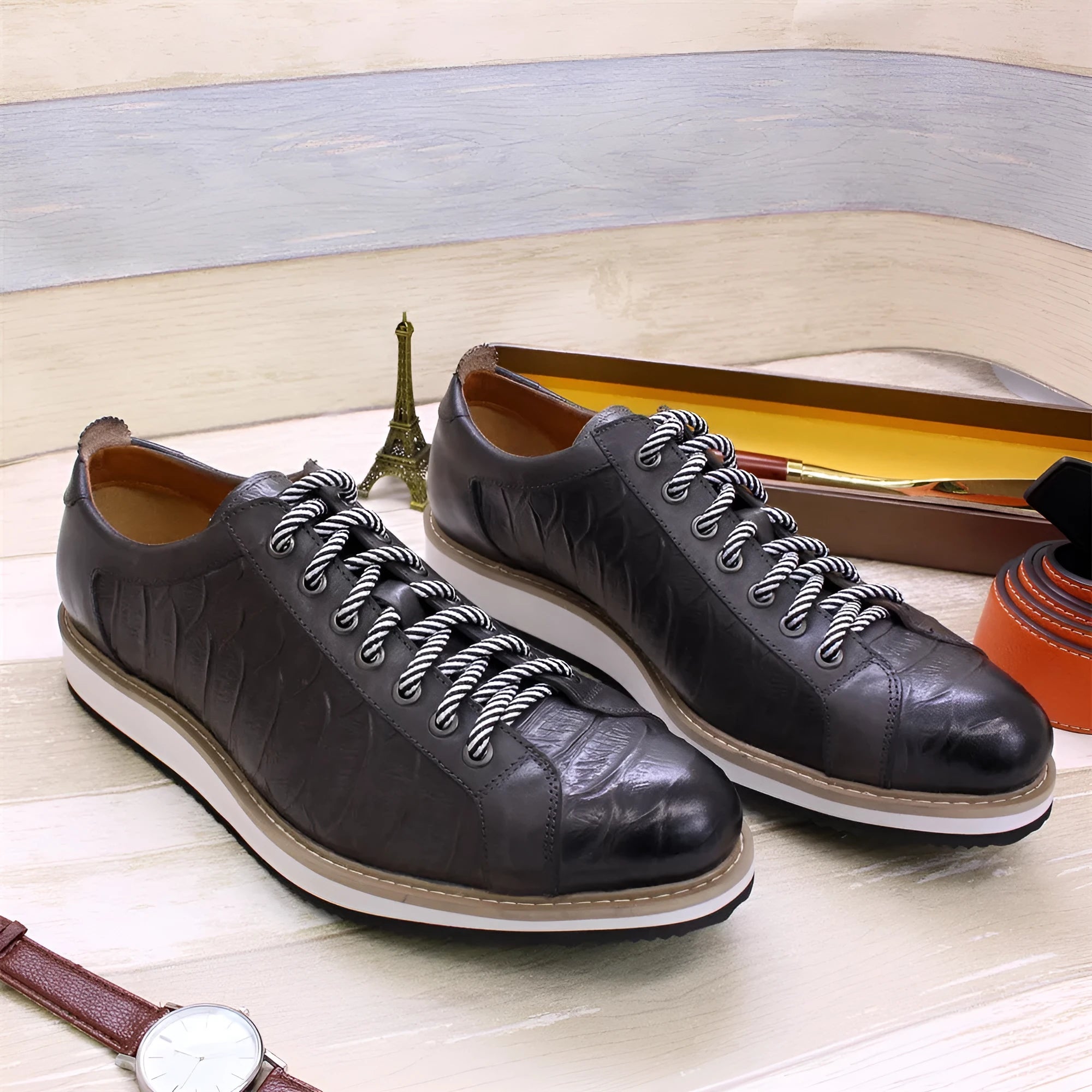 Men's low-tube shoes with an embossed pattern on the upper and a front tie lace closure.
