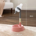 Green adjustable height pet water dispenser with detachable bowl and ball-tip nozzle on a kitchen floor.