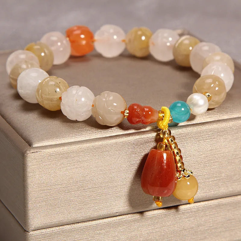 Women's khaki yellow agate crystal bracelet on a gold silk cord.