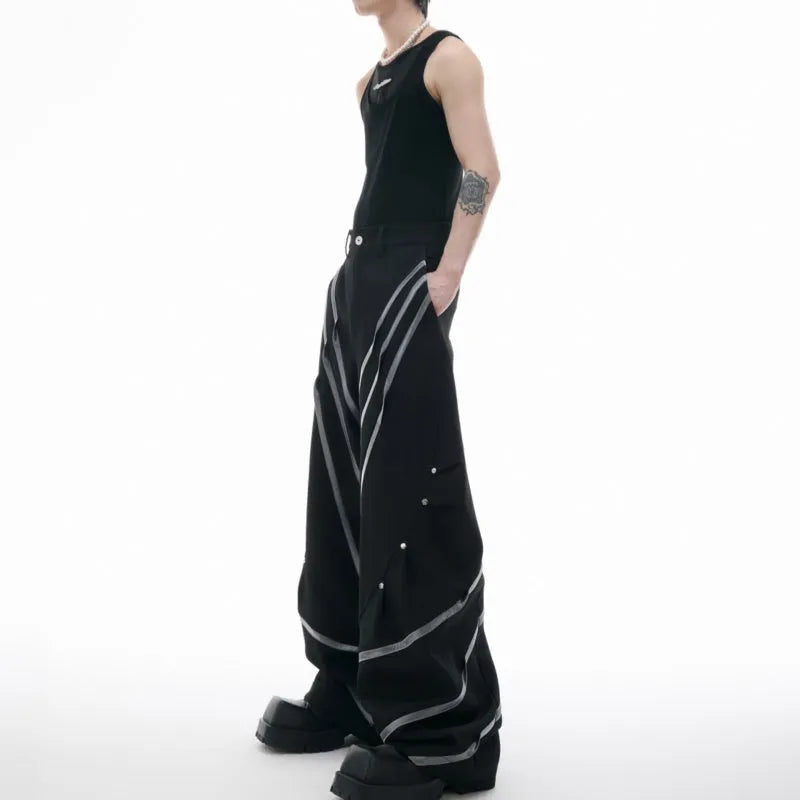 Men's polyester trousers with metal rivet accents and pleated detailing on three-dimensional cutting construction