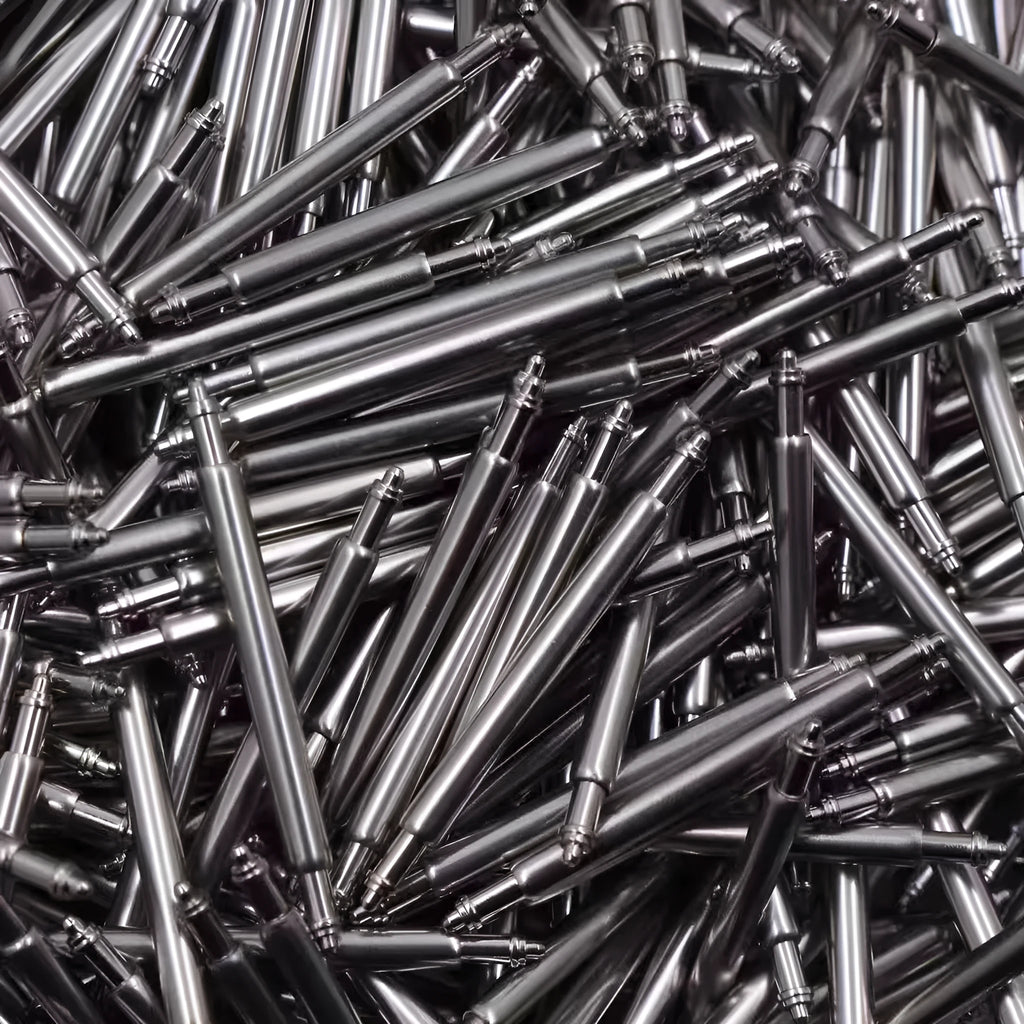 Watch repair parts set showing bolts, auricular needles, springs, and shafts in sizes 21mm to 26mm