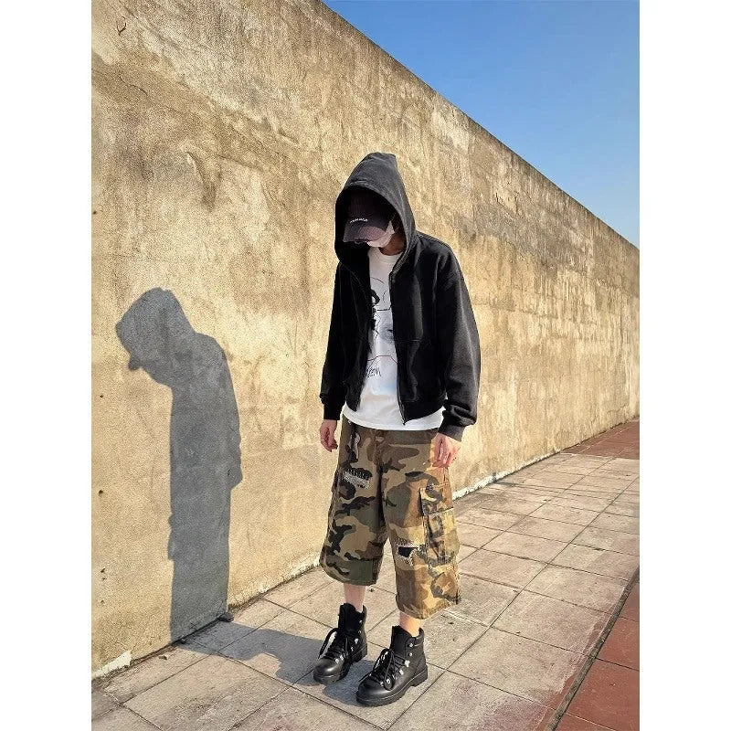 Men's retro patch ripped camouflage cropped jeans showing loose straight leg fit and distressed detailing