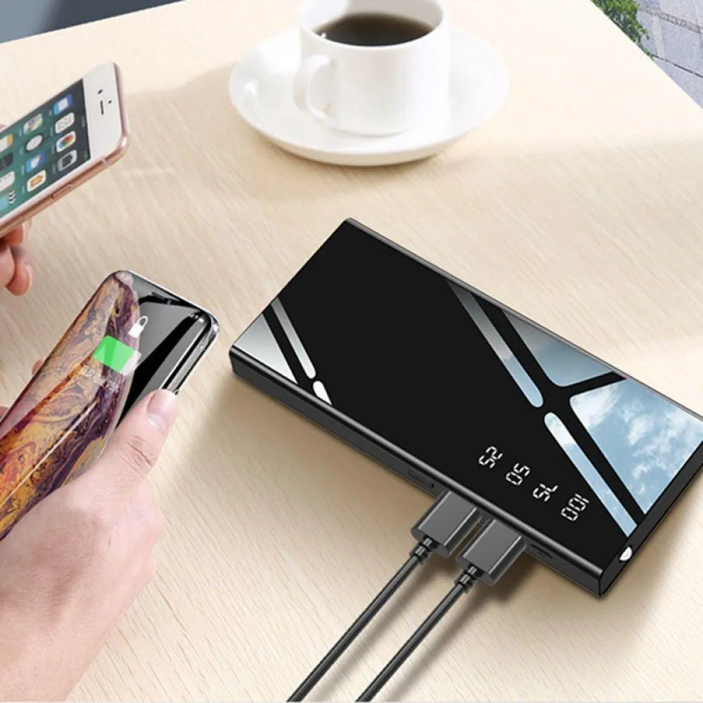 Black 20000mAh power bank with LCD percentage display showing dual USB output ports
