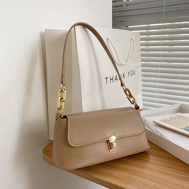 Brown French casual underarm bag with single shoulder chain, showing horizontal square shape and sandwich pocket design