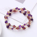 Women's adjustable three-ring bracelet with tourmaline, strawberry quartz, and amethyst crystal beads on elastic cord.