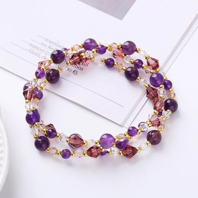 Women's adjustable three-ring bracelet with tourmaline, strawberry quartz, and amethyst crystal beads on elastic cord.