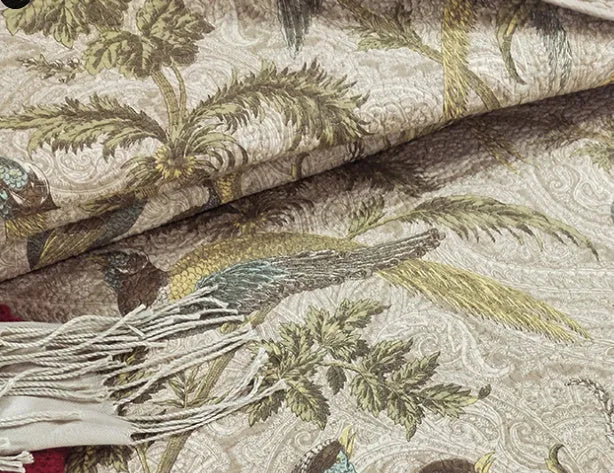Blue American floral and bird pattern cotton bedspread quilted set of three pieces on a bed.