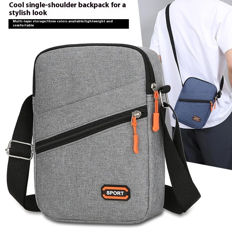 Lightweight Oxford cloth crossbody commuter bag in a solid colour with contrast detailing.