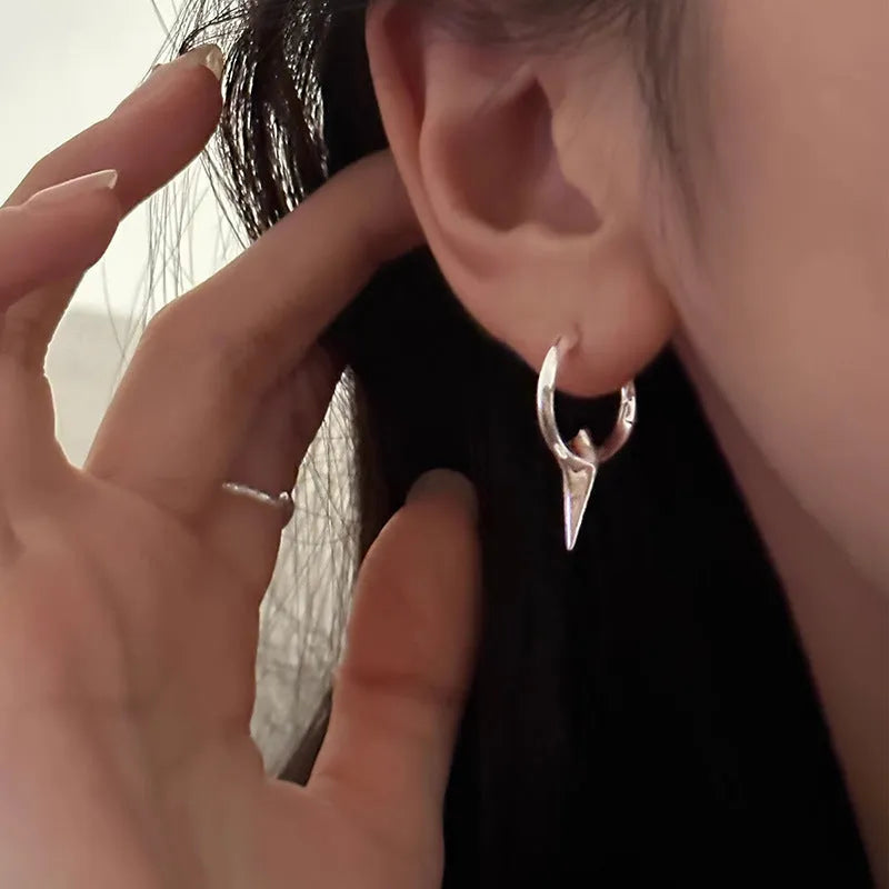 A pair of platinum-coloured geometric star-shaped clip-on earrings for women, made from electroplated copper.
