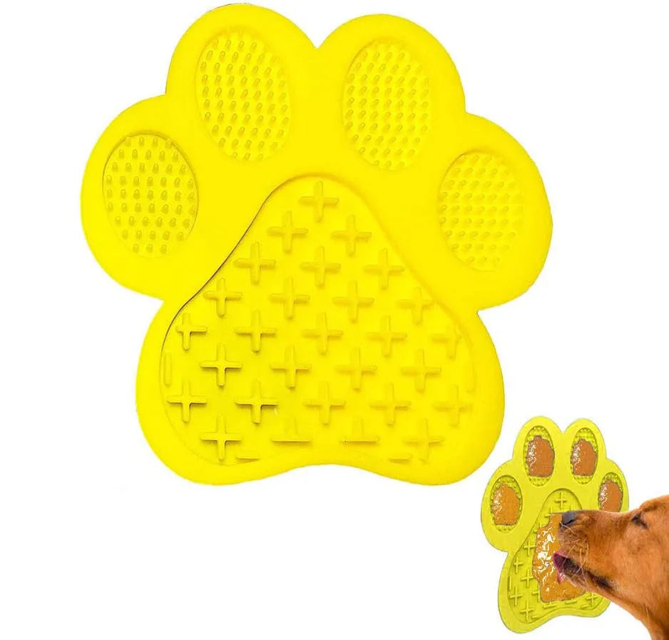 Blue bone-shaped silicone dog licking mat with suction cups on back, held against a tile wall.