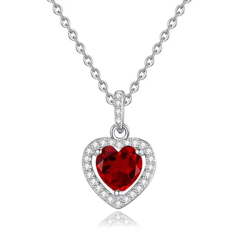 Women's sterling silver heart pendant necklace with natural gemstone on a cross chain.