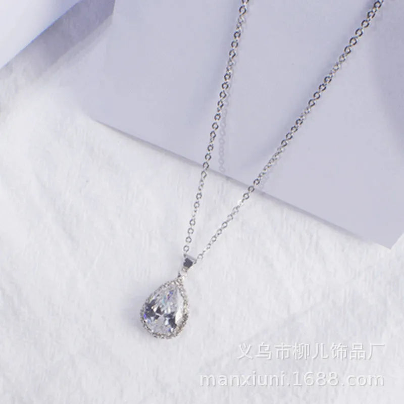 Rose gold electroplated necklace with water drop shaped geometric pendant and rhinestone detailing