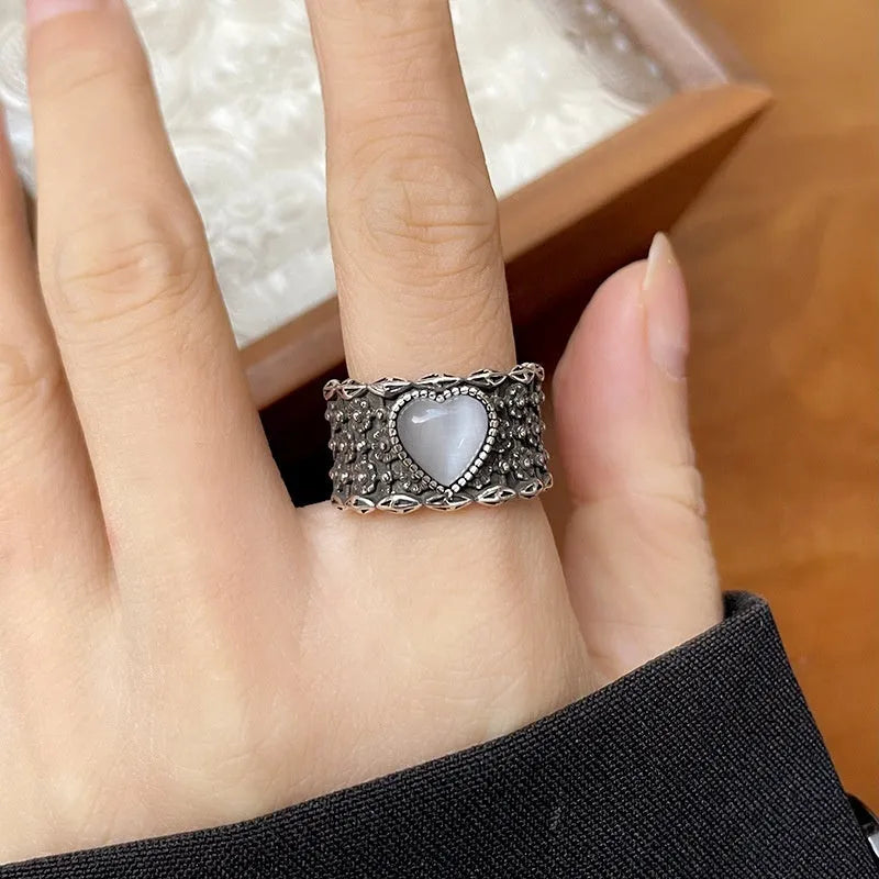 Retro wide-faced heart-shaped ring with adjustable opening in silver finish.