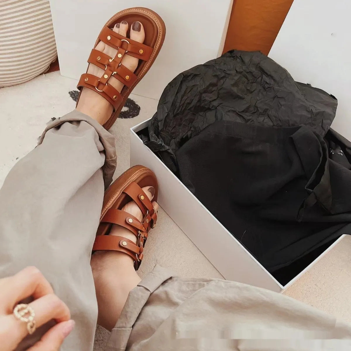 Women's retro Roman sandal slippers in black patent leather with sheepskin upper, shown from the side.