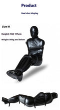 Black patent leather full-coverage body wrap with six ratchet tie down straps laid out.