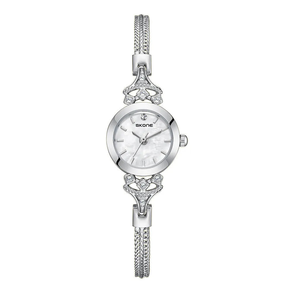 Women's quartz watch with gold white face and slim 8mm profile.