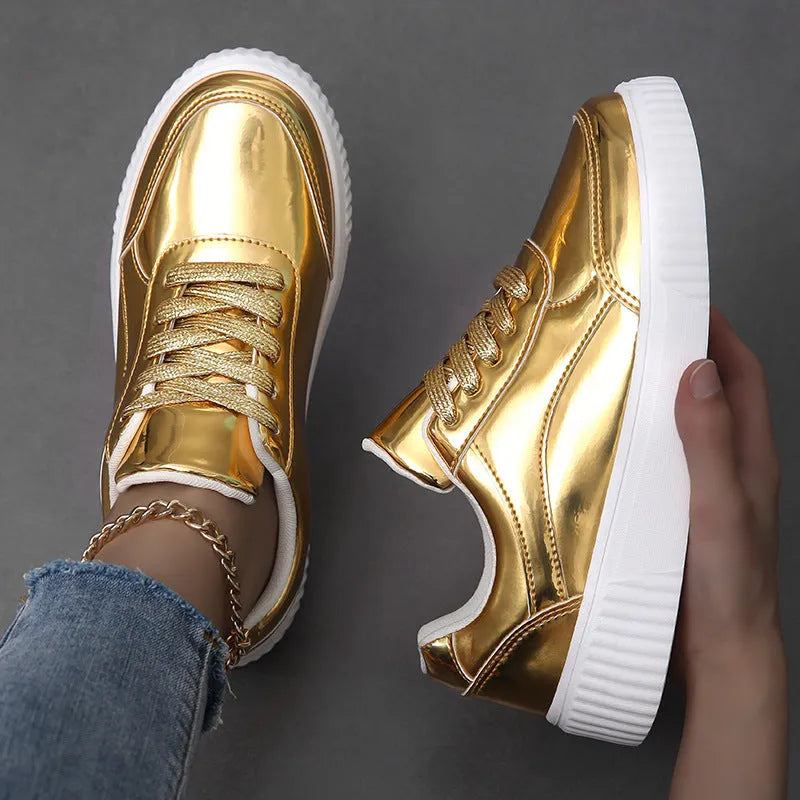 Gold sequinned unisex platform sneaker with thick sole and stitching detail on a white background.