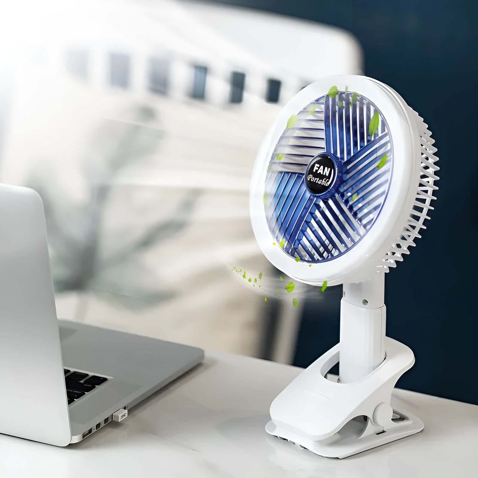 White and blue plastic rechargeable clip fan with USB cable, 29x18cm, clamped on a desk edge