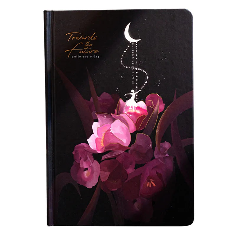 A5 notebook with luminous blue cover open to show colour illustration pages inside