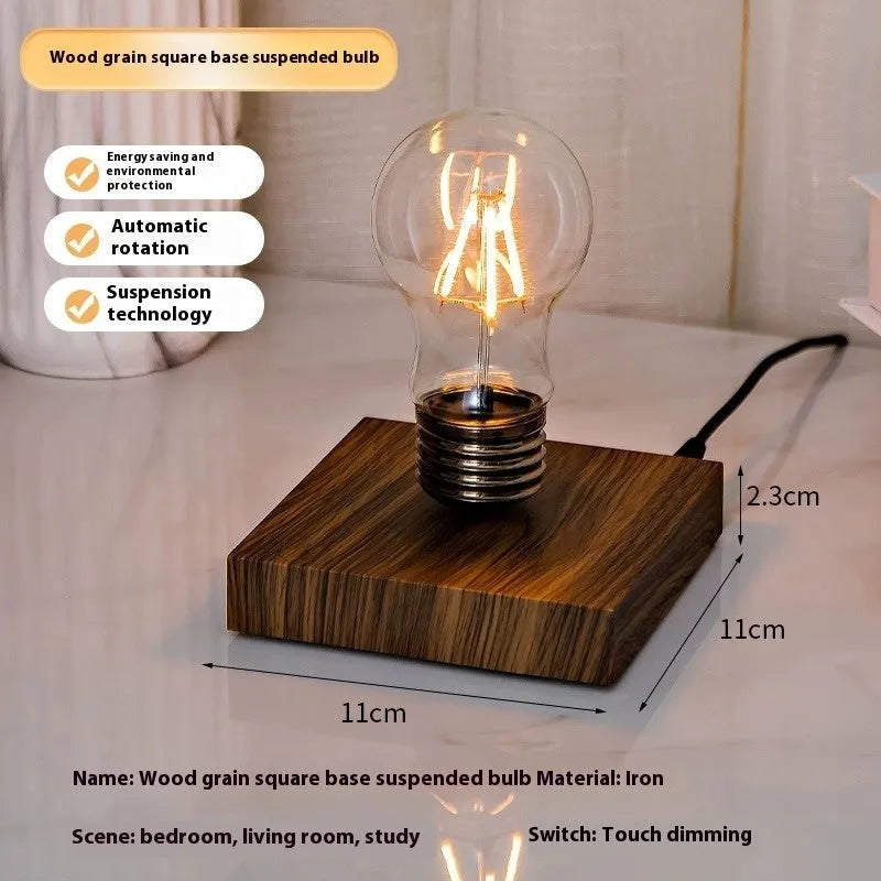 Iron art suspension bulb night lamp on a black wood grain desktop base.