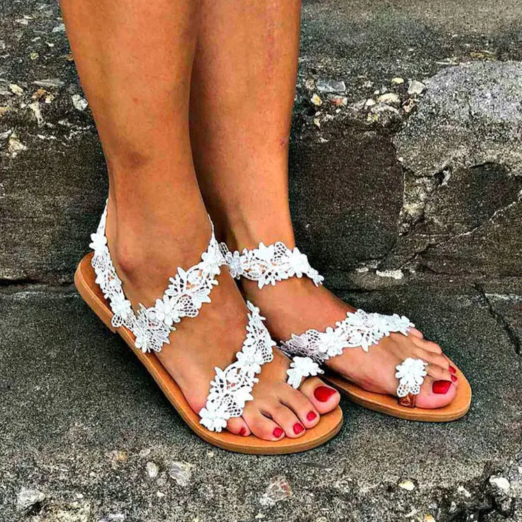 White women's flat sandals with rhinestone and flower decoration on the PU upper.