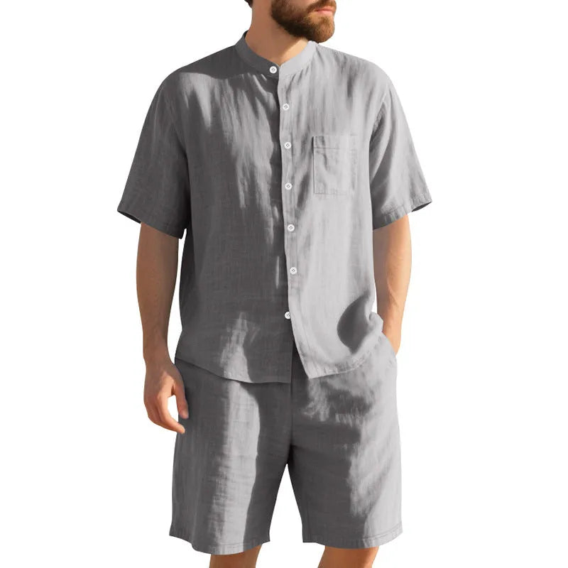 Men's light blue linen blend summer suit with Henry collar shirt-style jacket and matching shorts on a hanger.
