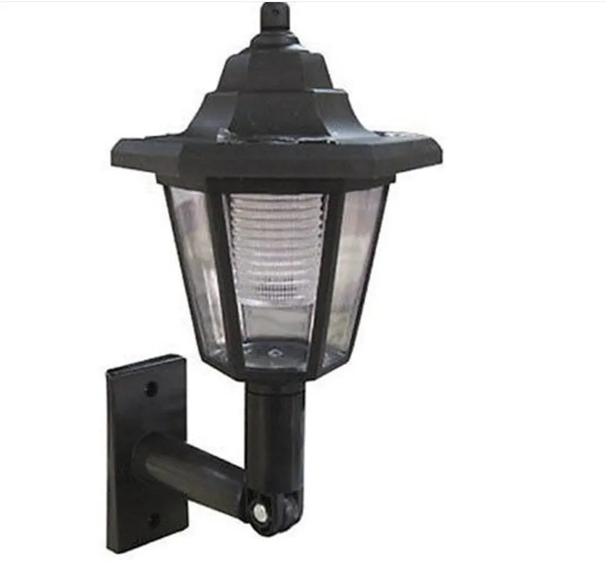 Black hexagonal solar wall light for outdoor mounting with automatic light sensor