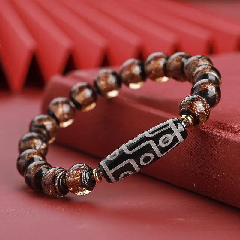 Close-up of a colourful handcrafted Chinese bracelet with snake lucky beads and auspicious patterns.