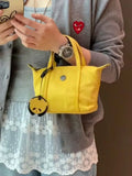 Casual lightweight nylon crossbody bag in dumpling shape, available colours black brown orange pink yellow, with pendant