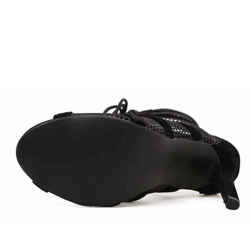 Black suede women's lace-up high heel shoes with 11.5cm heel shown from side view