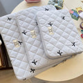 White laptop storage bag with rhombus embroidery and bow design in nylon fabric