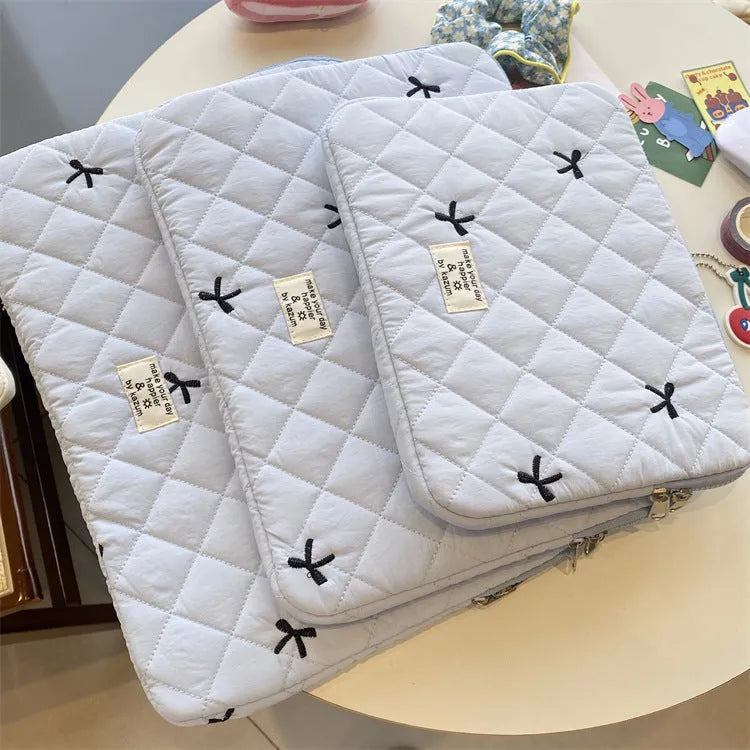 White laptop storage bag with rhombus embroidery and bow design in nylon fabric