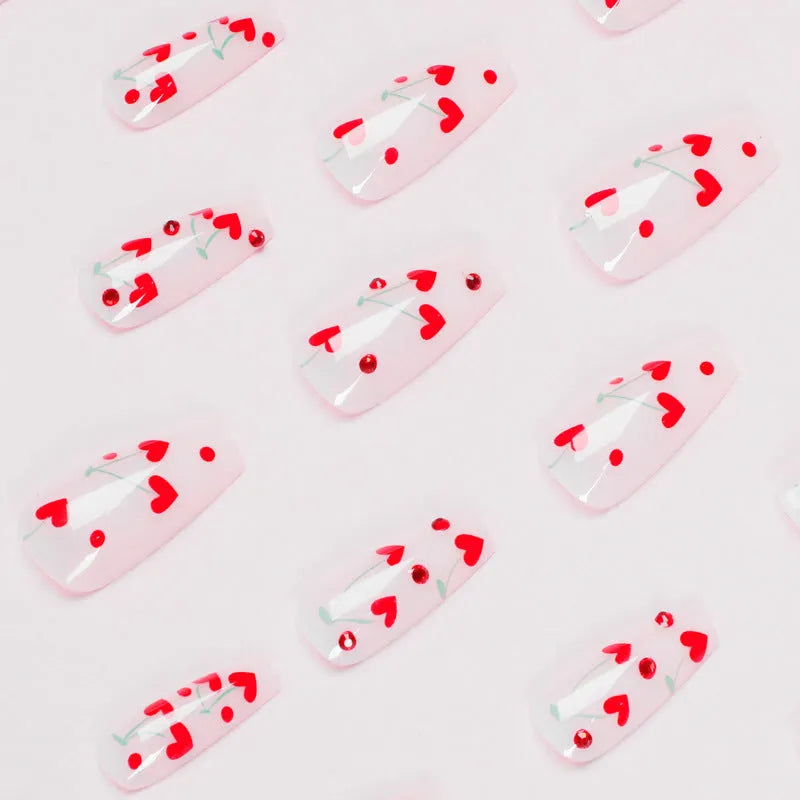 Red diamond and small cherry pattern French tip nail art stickers in a pack of 24 with adhesive glue.
